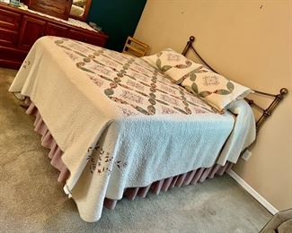 Brass bed, pretty quilt type bedding