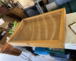 Wooden display case with hinged glass front door.                                      36" W x 24" L x 4.5" D                                                                                                  $45