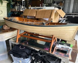 Decorative wooden boat w/ stand, netting & 2 oars. $100 