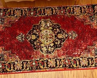 one of 2 matching rugs, one large one small.