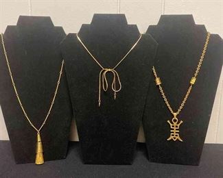 Three Gold Colored Necklaces With Some Flair