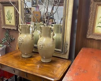 Beautiful table topped with olive jars and a fabulous French mirror - feels like a trumesu mirror but not as much of a head on it.