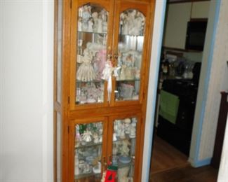 curio filled with angels and fairies and Dresden