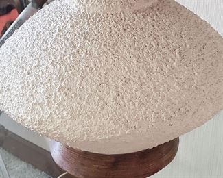 Lamp has a raised design/wood base