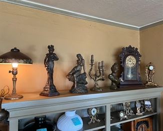 Art Nouveau sculpture statues, antique lamps and candelabra, and vintage mantel clocks. 