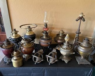 Antique kerosene lamps, electric lamps, and candelabra from varying makers. Dated from 1800s to circa 1920s. 