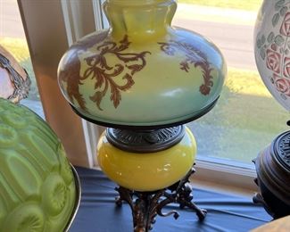 Very rare antique B & H Duplex (Bradley and Hubbard) Kerosene Lamp with cast iron dragon shaped legs, a beautiful vibrant yellow glass mid section, and a green and yellow decorated shade with Chinese Lions depicted in wonderful detail. Incredibly unique!