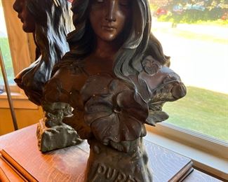 Antique statue of a young woman surrounded by flowers, titled, Purete, and attributed to Boston Plaster Art, appears to be made of patinated plaster. 