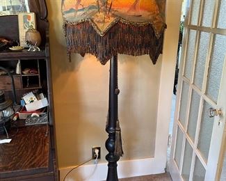 Fantastic antique floor lamp with elaborate decorated shade with long bead fringe, featuring a coastal water scene with a sailboat and birds