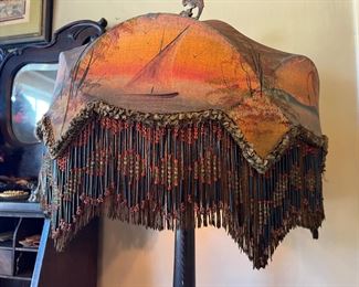 Fantastic antique floor lamp with elaborate decorated shade with long bead fringe, featuring a coastal water scene with a sailboat and birds