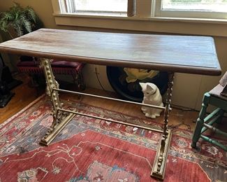 Cast iron or steel based wood table with decorative metal legs marked "Edwards & Co. Liverpool" (which is attributed to the John Edwards & Co Shipping company of U.K. England, which operated roughly from the mid 1800s to the early 1900s)