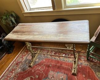 Cast iron or steel based wood table with decorative metal legs marked "Edwards & Co. Liverpool" (which is attributed to the John Edwards & Co Shipping company of U.K. England, which operated roughly from the mid 1800s to the early 1900s)