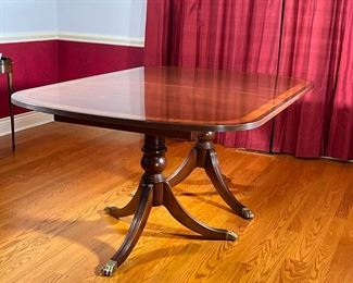 DOUBLE PEDESTAL DINING ROOM TABLE | Duncan Phyfe style dining table, mahogany with inlay top, double pedestal base and two leaves; with Ethan Allen "18th Century Mahogany" label underneath, brass capped feet. - l. 70 x w. 46 x h. 29 in