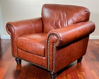 ITALIAN LEATHER ARMCHAIR | Divani Chateau d'Ax caramel brown leather armchair, with brass rivets on border of arms and base with spindle legs.- l. 37 x w. 40.5 x h. 36 in
