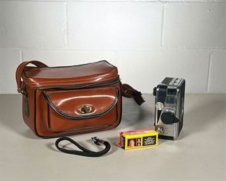 DEJUR FADEMATIC 8MM CAMERA & CAMERA BAG | Includes: 8mm film Movie Camera, original owner's manual, unopened 620 Color film, and leather carrying case. - l. 9 x w. 6 x h. 6 in (Leather camera bag)
