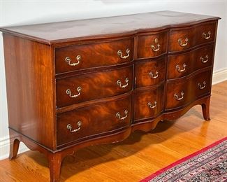 TRIPLE MAHOGANY DRESSER | Long dresser having six drawers, serpentine front with brass pulls. - l. 63.5 x w. 21 x h. 34 in