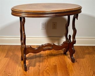 OVAL SIDE TABLE | Walnut Oval Table with cut out sides and shaped stretcher. - l. 32 x w. 18 x h. 27.5 in