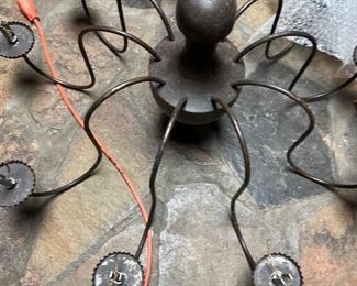 Metal light fixture has candle covers