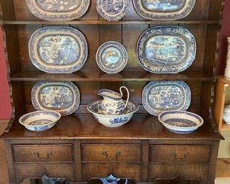 antique blue and white dishes housed in a large oak hutch