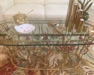 Oval glass and gold-toned metal coffee table