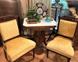 A pair of antique chairs; Eastlake marble-top table