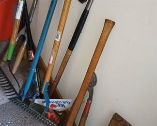 Assortment of Rakes, Axes, and Gardening Tools
