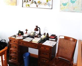 Desk with desk chair.  Lots of office supplies.  