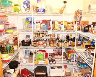 Pantry is full of canned goods, plastic ware and small appliances.  