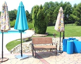 Patio umbrellas, glider bench and swim pool floats.