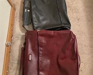 Samsonite Softsided Garment Bag on cranberry the other blue Folder in half with Samonite logos shown