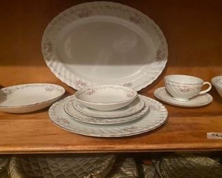 One Place Setting has 7 Pieces - dinner plate, salad plate, dessert plate, small bowl, large bowl, cup, and saucer - plus there are three serving bowls and round and oblong serving plates - 88 pieces in total