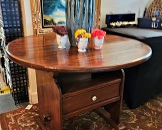 Antique Victorian table chair. Table top flips up and becomes a chair. Also has a drawer.