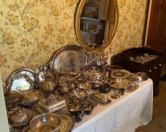 Piles of luxurious silverplated items.