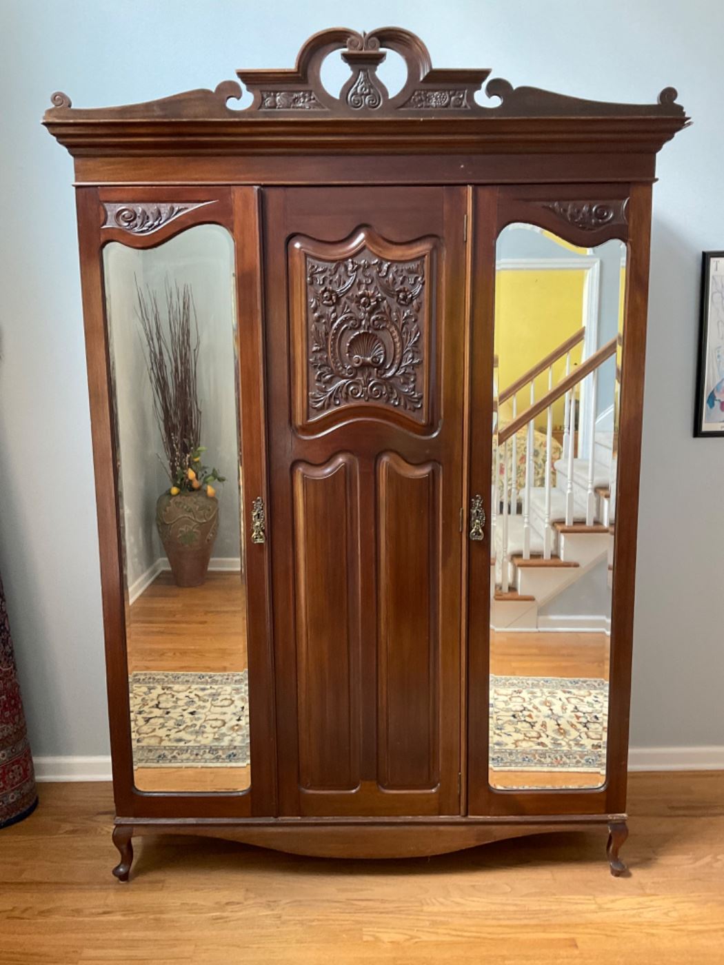 Antique Walnut English Armoire with hand carved details was made in England about 1900. This armoire disassembles into four pieces for easy moving.                                                        