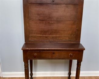 This is an early 19th Century Sheraton style drop front cherry Paymaster Desk. If this desk could talk, it would tell some interesting stories about the generations of people who worked on it!
