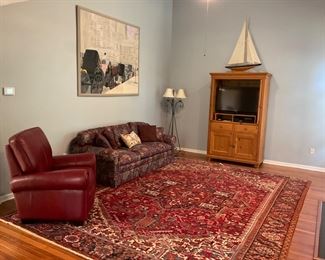 The pattern of this Persian rug is Herez. It is 10'5"x14 and is hand woven wool pile/Cotton Warp. This rug is in excellent condition of dark reds and blues!