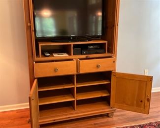 ENTERTAINMENT CENTER THAT CAN BE CONVERTED TO AN ARMOIRE.