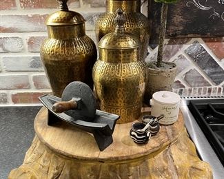 Brass jars, topiary, decorative tray. 