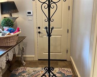 Very nice and heavy wrought iron coat rack. The rug underneath is available as well. There is another picture that shows the entire rug. 