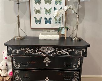 LRge chest of drawers and adjustable brass lamps.  