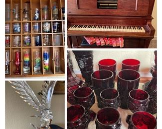 Red colored glass, handblown eagle statue, variety of shot glasses and  a player piano.