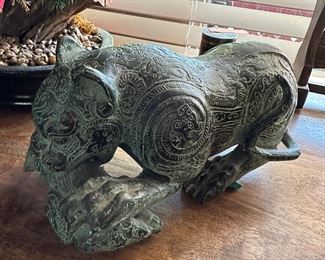 Unusual green and black brass type tiger with prey