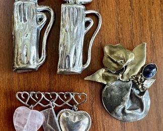 Item 21: (2) Sterling Silver Golf Bag Pins (top left): $30/Each Item 22: Sterling Silver Pin with Purple Stone (right): $26 Item 23: Sterling Silver Heart Pin (bottom): $30