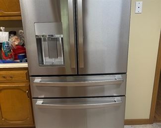 GE STAINLESS REFRIGERATOR APPROXIMATELY A YEAR OLD