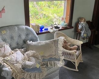 Blue Chair, lace pillows, wicker child’s rocker. 