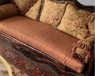 Vintage leather and carved wood couch