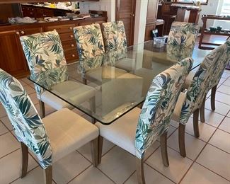 7' long dining table with inch thick glass top and two authentic, coral pedestals in triangular shape plus 8 chairs with tropical upholstery in perfect condition