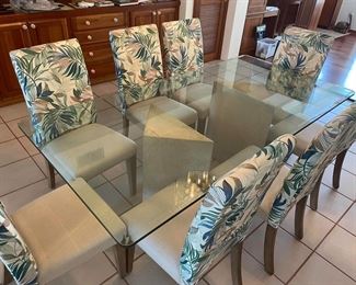 7' long dining table with inch thick glass top and two authentic, coral pedestals in triangular shape plus 8 chairs with tropical upholstery in perfect condition