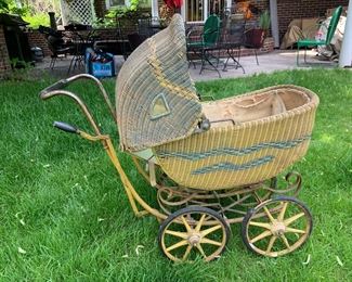 Charming vintage wicker doll pram with working wheels and brake