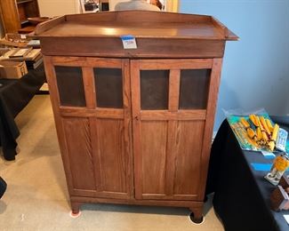 MISSION OAK STYLE. CABINET. IT HAS BEEN CONVERTED INTO A ENTERTAINMENT CENTER.